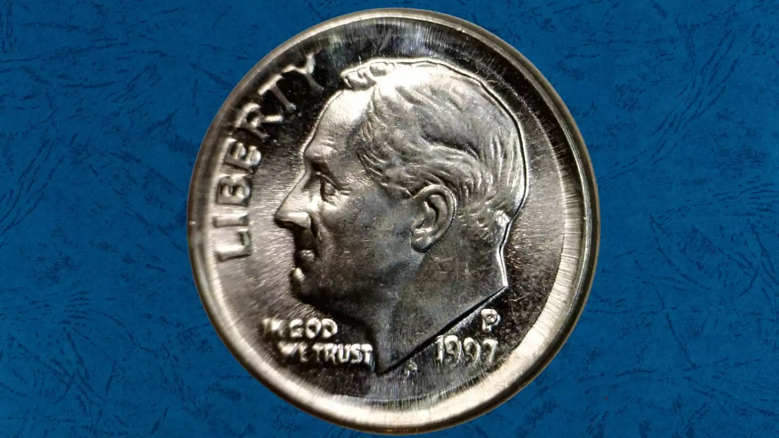 1997 dime broad strike error showing coin wider than normal with design spread to the edge